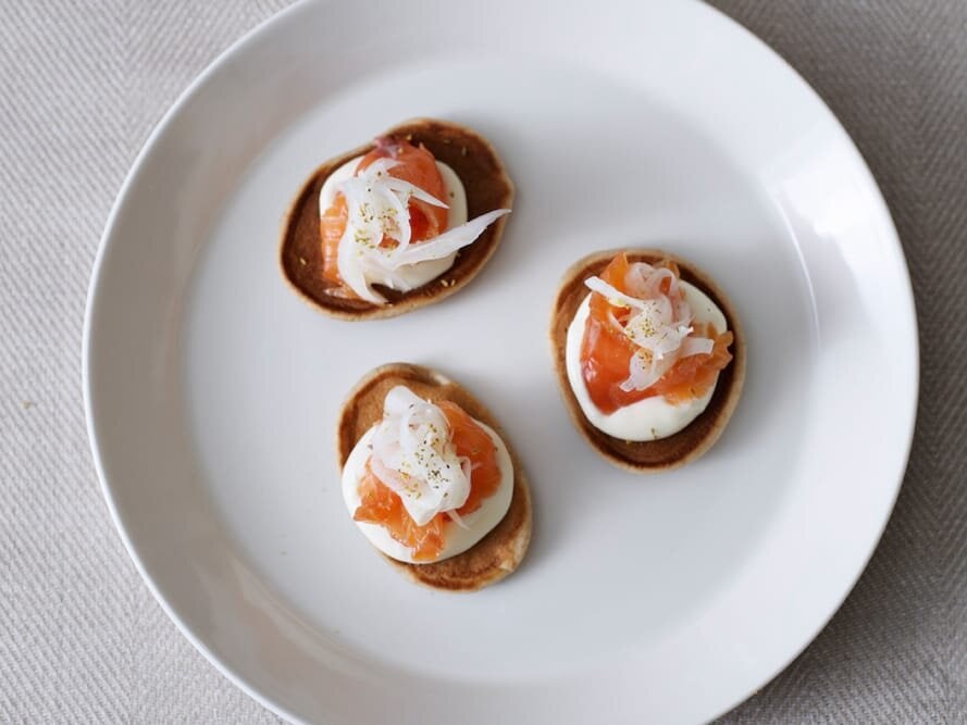 Cured Norwegian salmon with a shot of Linie aquavit, rye & sour cream pannekaker (pancakes) and pickled fennel