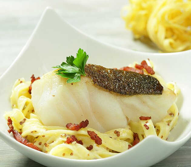 Norwegian cod fillet in mustard sauce, fettuccini and bacon cubes 
