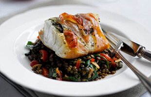 Prosciutto baked Norwegian Cod with warm spinach & puy lentil salad