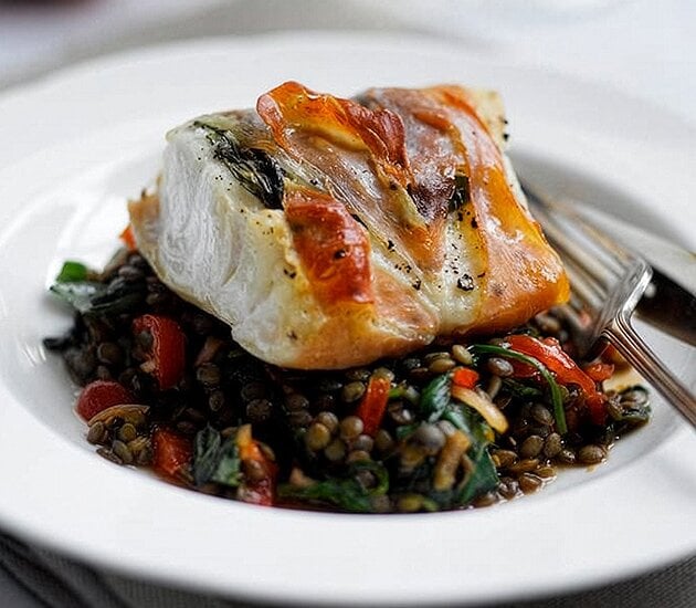Prosciutto baked Norwegian Cod with warm spinach & puy lentil salad