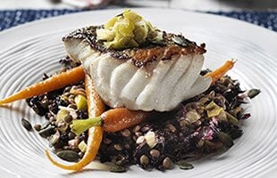 Lightly poached SKREI® with leek butter, puy lentils, kale and pumpkin seeds