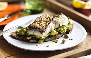 Sautéed SKREI® on rye with smashed avocado, habanero tabasco, roasted pistachios and lemon