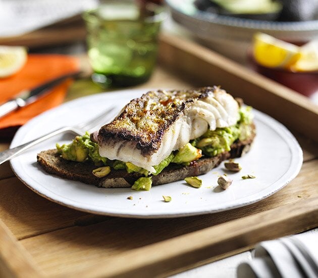 Sautéed SKREI® on rye with smashed avocado, habanero tabasco, roasted pistachios and lemon