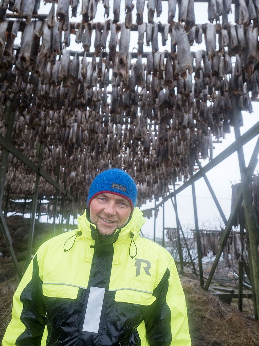 Pål Arild in front of drying racks for stockfish